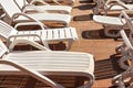 Empty white plastic sunbeds at holiday resort near pool, closeup detail Royalty Free Stock Photo
