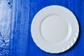 Empty white plate on blue and white wooden background Royalty Free Stock Photo