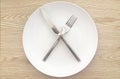 Modern White Plate and Silverware with Natural Wood Background