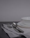 Empty white plate and cutlery, table setting on the wooden table, flat lay
