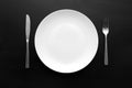 Empty white plate on dark wooden table Royalty Free Stock Photo