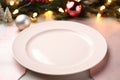 Empty white plate on decorated table. Christmas, New Year background