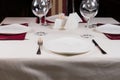 Empty white plate in a formal table setting