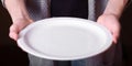 Empty white plate in the hands of have human Royalty Free Stock Photo