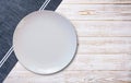 Empty white plate and napkin on light grey table, flat lay Royalty Free Stock Photo