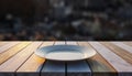 Empty white plate on a rustic wooden table with a blurred city background dish ceramic Royalty Free Stock Photo