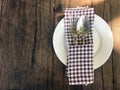 Empty white plate with silverware, spoon and fork and brown scot Royalty Free Stock Photo