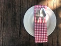 Empty white plate with silverware, spoon and fork and red scoth Royalty Free Stock Photo