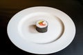 empty white plate with a single piece of sushi in the center Royalty Free Stock Photo