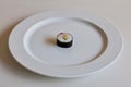 empty white plate with a single piece of sushi in the center Royalty Free Stock Photo