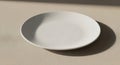 Empty White Plate on Textured Surface Royalty Free Stock Photo