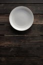 Empty white plate on a wooden loft table Royalty Free Stock Photo