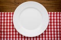 Empty white plate on wooden over red grunge Royalty Free Stock Photo