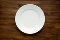 Empty white plate on wooden table Royalty Free Stock Photo
