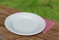 Empty white plate on wooden table Royalty Free Stock Photo