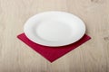 Empty white plate on wooden table Royalty Free Stock Photo