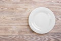 Empty white plate on wooden table. Template for your design Royalty Free Stock Photo