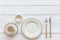 White plates and cup for table setting on white wooden background top view mockup Royalty Free Stock Photo