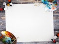 Empty white poster paper with space for mock up on wood background with color palette, paintbrush and paint colors Royalty Free Stock Photo