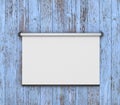 Empty white projector screen hanging from painting Royalty Free Stock Photo