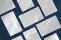 Empty white rectangle business card mockups lying diagonally on dark blue concrete background Royalty Free Stock Photo