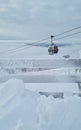 Empty white red closed ski lift cabin no people and white dramatic snowy mountains background. End of season concept Royalty Free Stock Photo