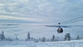 Empty white red closed ski lift cabin no people and white dramatic snowy mountains background. End of season concept Royalty Free Stock Photo