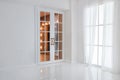 Empty white room with big window and glass french door with bright orange lights Royalty Free Stock Photo