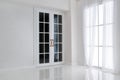 Empty white room with big window and glass french door