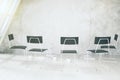 Empty white room with chairs, cups of coffee and othe accesories on the floor Royalty Free Stock Photo