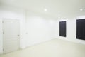Empty white room with door and window Royalty Free Stock Photo