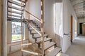 Empty white room without repair and furniture with scaffolding with wooden stairs