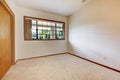 Empty white room with wood door and beige carpet. Royalty Free Stock Photo