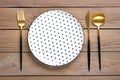 empty white round plate with black peas, fork, knife, spoon on wooden table Top view Flat lay Dishes for breakfast, lunch or Royalty Free Stock Photo