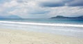 Empty white sand beach with little stones and clear blue ocean waves at Bajawa Ruting Flores.