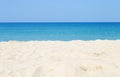 Empty white sandy beach over blurred blue sea and clear sky background Royalty Free Stock Photo