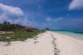 Empty White Sandy Beach with the Palm Trees and Blue Ocean Water on the Paradise Maafushi Island Royalty Free Stock Photo