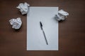Empty white sheet, pen and crumpled paper on wooden desk Royalty Free Stock Photo