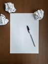 Empty white sheet, pen and crumpled paper on wooden office desk Royalty Free Stock Photo