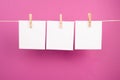 Empty white sheets of paper in a row hanging on a string, copy space for pictures and text, message communication and marketing ba Royalty Free Stock Photo