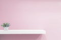 Empty white shop shelf, retail shelf on pink vintage background. Royalty Free Stock Photo