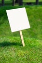Empty white sign board on a small hill with freshly cut green grass Royalty Free Stock Photo