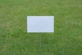 Empty white sign on the lawn Royalty Free Stock Photo