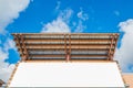 Empty white space bill board with wood and zinc roof with blue sky.ready for product display montage. Royalty Free Stock Photo