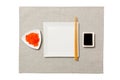 Empty white square plate with chopsticks for sushi, ginger and soy sauce on grey napkin background. Top view with copy space for Royalty Free Stock Photo