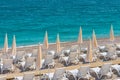Empty white sun loungers white umbrellas at the sandy beach of Mediterranean Sea, vacation summer Royalty Free Stock Photo