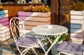 Empty white table and couple chairs on street outside a cafe bar or restaurant