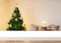 Empty white table top and blurred Christmas interior on the background. Xmas time. Copy space for your object, product Royalty Free Stock Photo