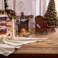 Empty canvas napkin on wooden desk top view. Festive sparkling Christmas interiors background
