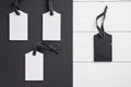 Empty white tags in a row on white and black wooden background. Top view. Mock up sample. Blank price tag on wooden planks. Design Royalty Free Stock Photo